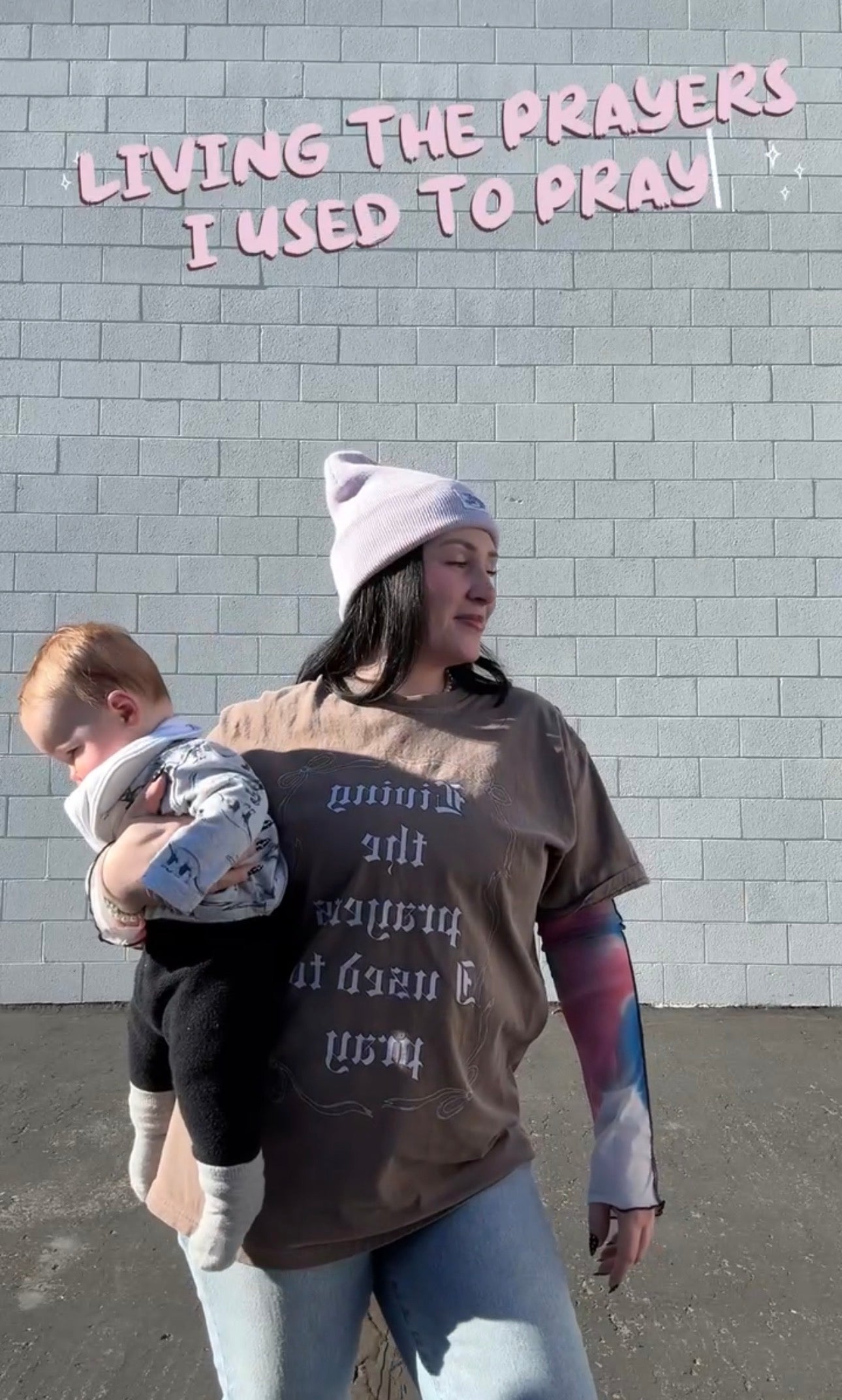 LOVE WORLD Living the Prayers I Used to Pray Tee in Espresso — Comfort Colors garment-dyed tee with old English lettering and bow graphic, front view on white background