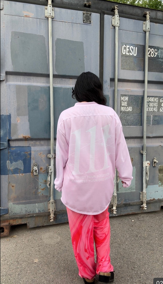 Pastel pink 111 angel number hockey-style jersey with LOVE WORLD sleeve graphic and intuition mantra on the back.