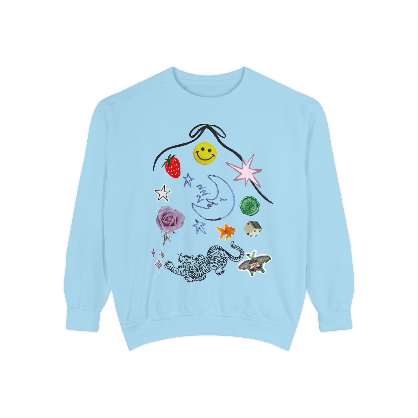 A light blue crewneck sweatshirt featuring a whimsical graphic print of a black bow, a yellow smiley face, a strawberry, a crescent moon, stars, a pink flower, a spotted cat, and a butterfly on a plain white background.