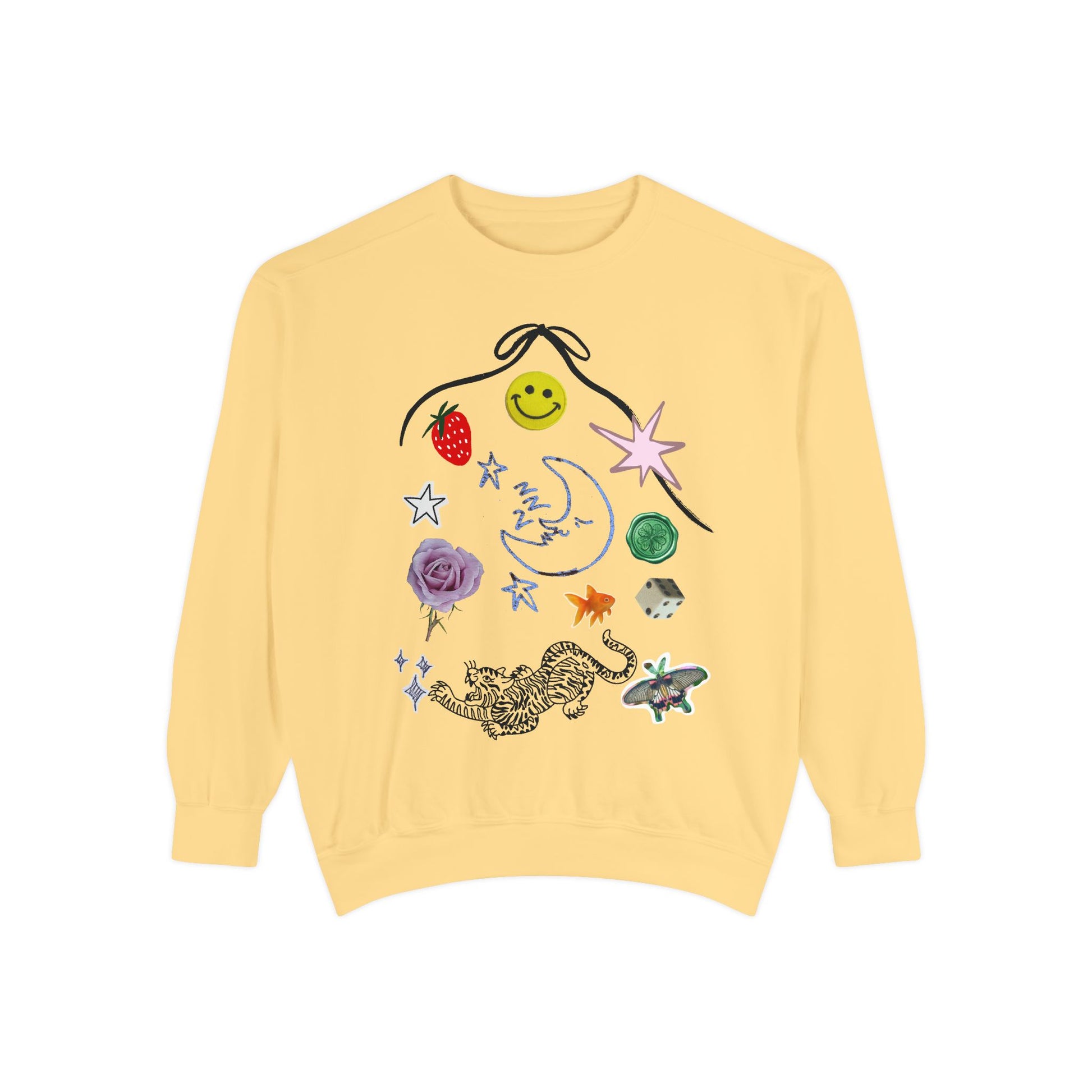 A pale yellow crewneck sweatshirt featuring a whimsical, multi-colored graphic print on the front with a smiley face, strawberry, stars, a crescent moon, a rose, a leopard, and a butterfly.