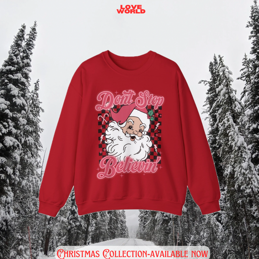 Red sweatshirt with Santa Claus graphic and text 'Don't Stop Believin'' against a snowy forest background.