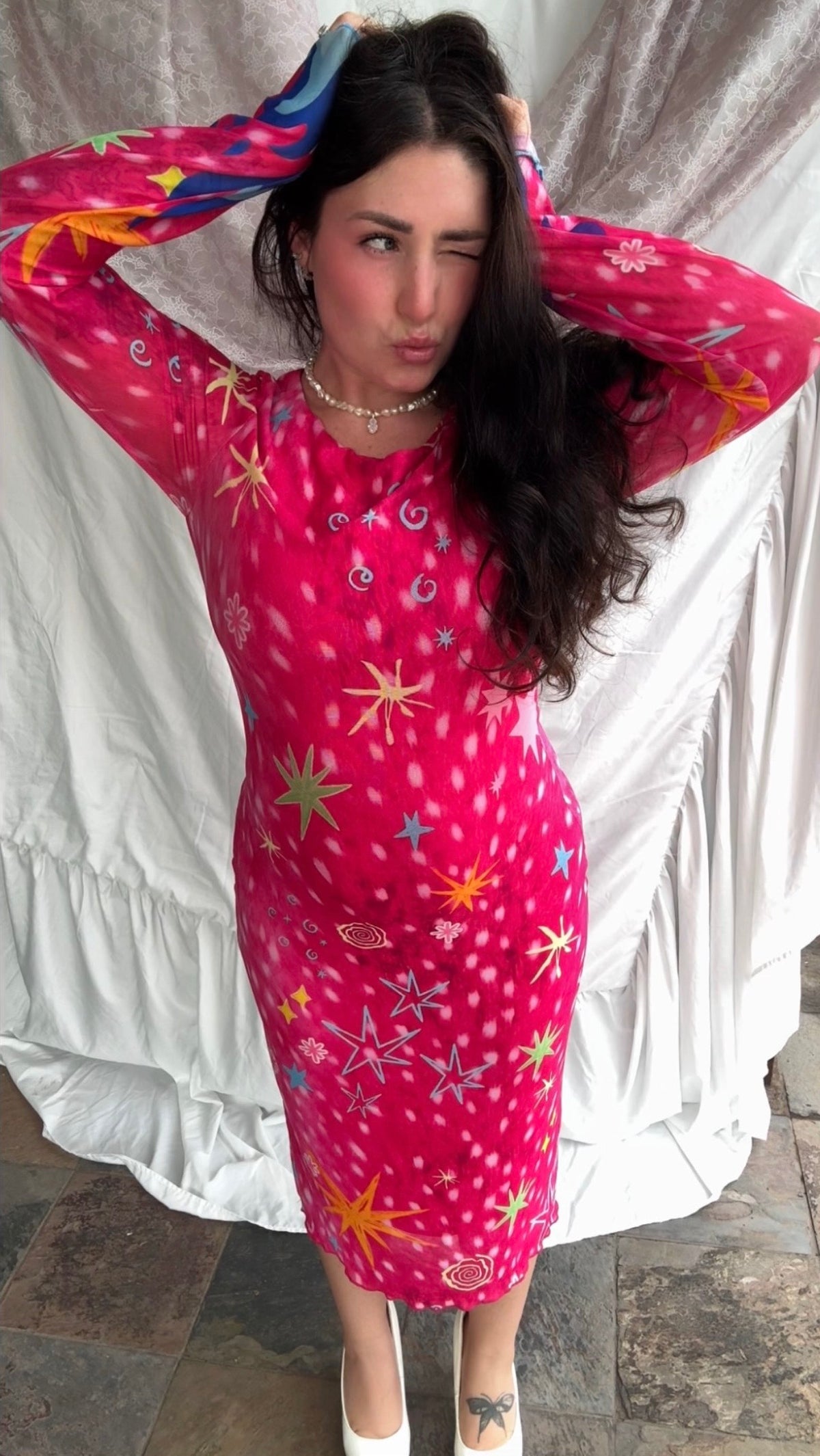 LOVE WORLD’s Deer Stars hot pink mesh midi dress with multicolored stars, spirals, and blue flame accents on long sleeves