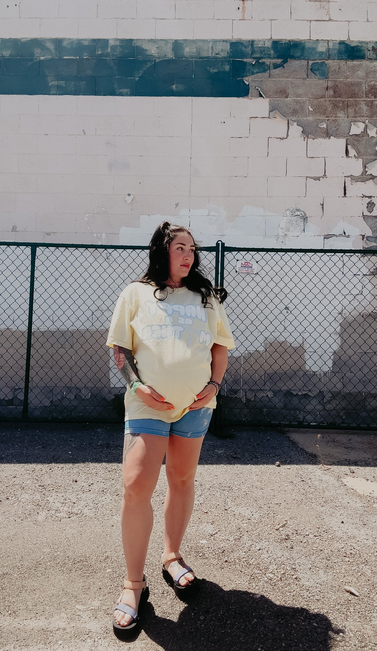 LOVE WORLD Happy As A Mother Tee in Banana — product mockup showing retro bubble letter graphic on yellow Comfort Colors garment-dyed tee