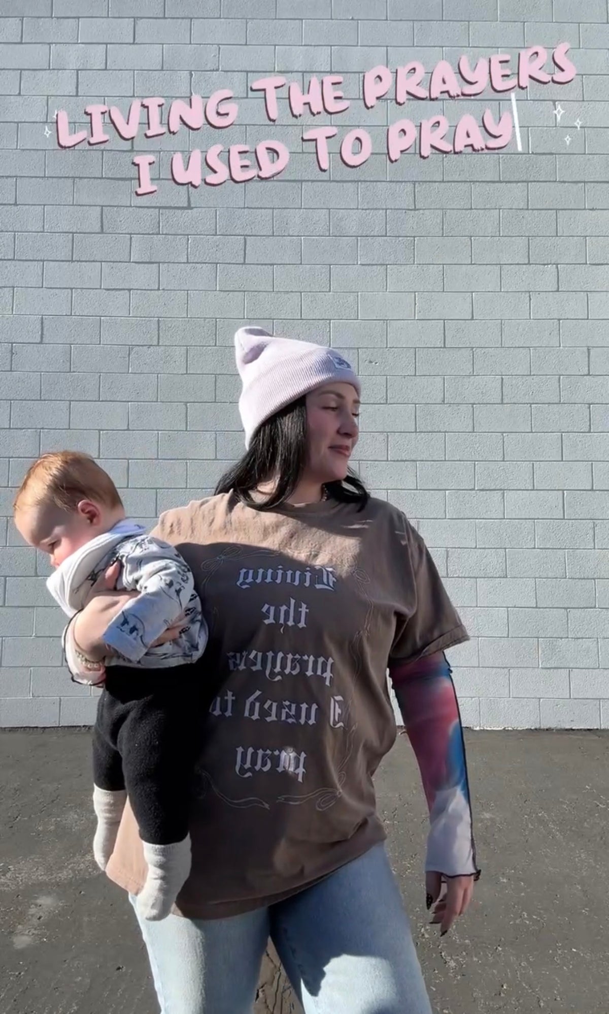 LOVE WORLD Living the Prayers I Used to Pray Tee in Espresso — Comfort Colors garment-dyed tee with old English lettering and bow graphic, front view on white background